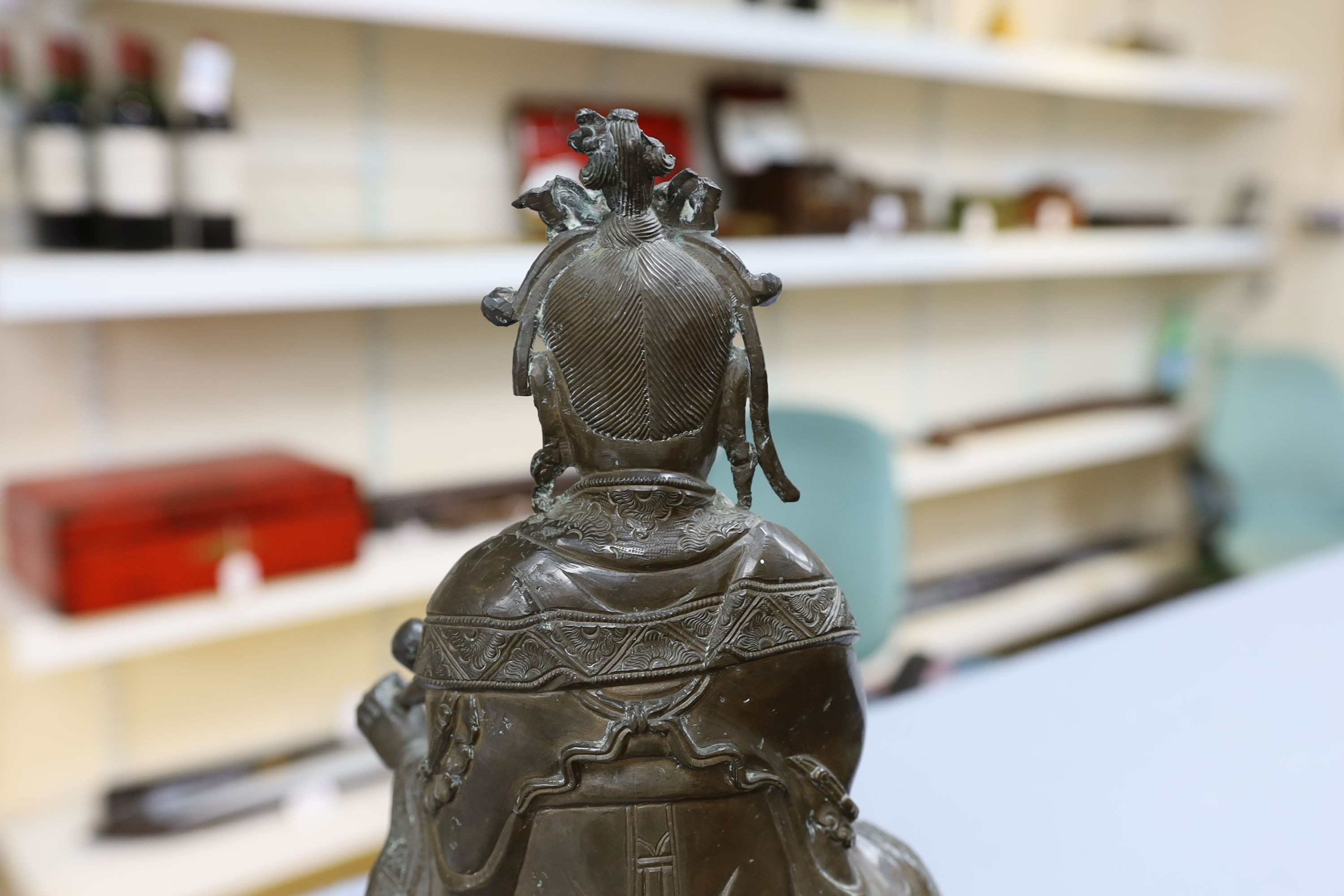 A large Chinese bronze group of Xi Wangmu and a child, late Ming dynasty, 31.5cm high excluding later wood stand